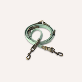 BioThane® original waterproof material, a mint green pet leash with dark metal hardware, coiled on a light cream background.